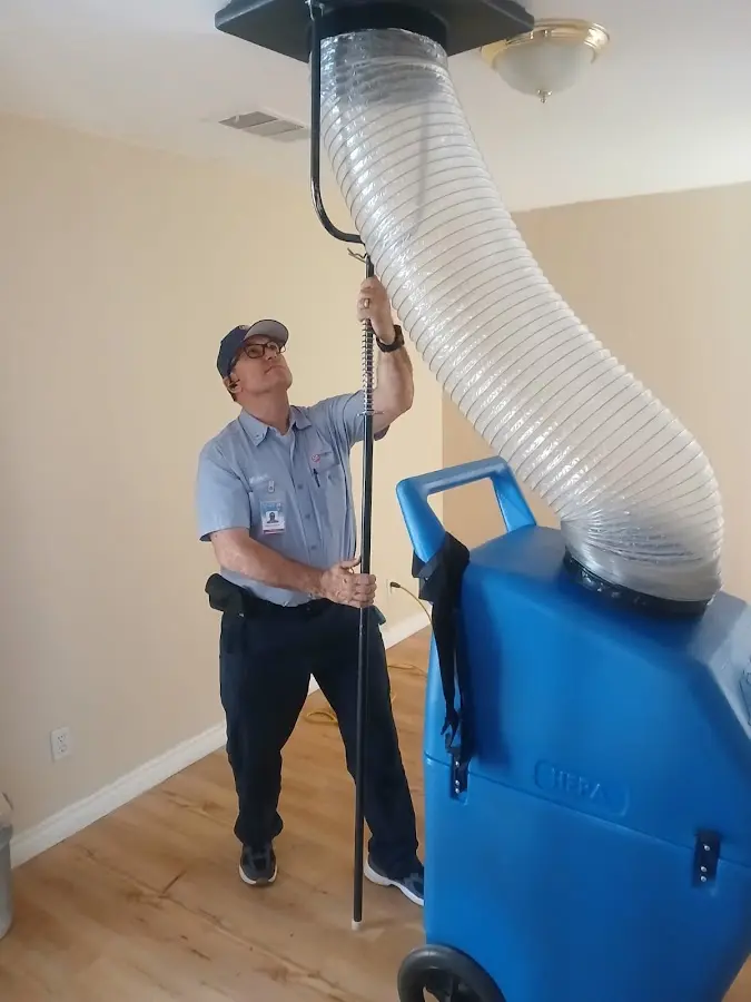 Furnace Tune-Up technician using HEPA equipment in Iowa City